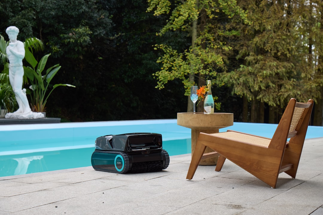 Minimal backyard pool with the Aiper automatic pool cleaner gliding by, combining style with efficient pool care.